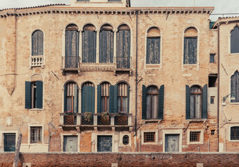 Old facade with wooden shutters in Venice