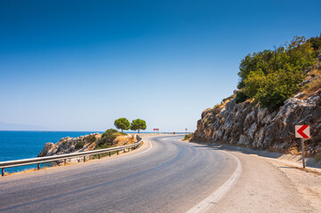 Winding road on the Mediterranean coast on the outskirts of Kemer, Antalya, Turkey. Road along the...