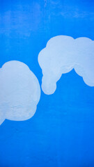 Cement walls that are painted blue and white with unique textures and beautiful patterns.