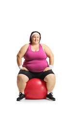 Corpulent woman sitting on an exercise ball