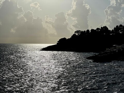 Dramatic sunset clouds above glittering sea at evening. 