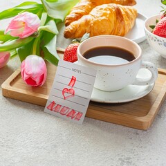 Happy mother's day, beautiful breakfast, lunch with cup of coffee (cappuccino) fresh croissants, strawberries on tray, bouquet of tulips as gift.