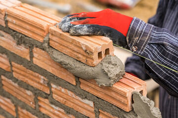 Hand worker masonry brickwork trowel construction site wall concrete background - 720050941