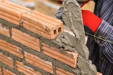Hand worker masonry brickwork trowel construction site wall concrete background - 720050950