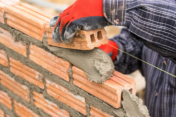 Hand worker masonry brickwork trowel construction site wall concrete background - 720050959