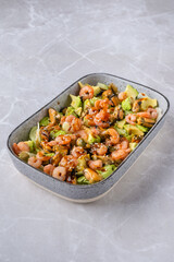 Bowl with salad with shrimp, mussels and avocado