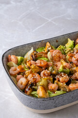 Closeup view of bowl with salad with shrimp, mussels and avocado