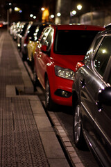 Red car in the street at night