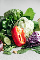 Red bell pepper, cabbage and cucumbers on the kitchen table.