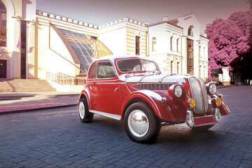 retro car near a private house on the road. Sunset. Bright car. Round headlights. High quality photo