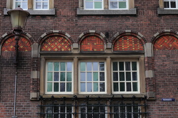 Fototapeta na wymiar Amsterdam Vredenburgh Building Facade Detail with Windows, Netherlands