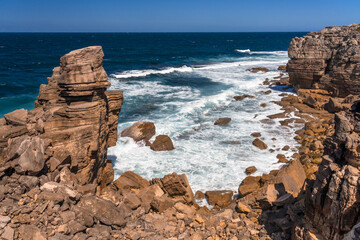 Rock formations in the site of geological interest of the cliffs of the Peniche peninsula, portugal, in a sunny day.