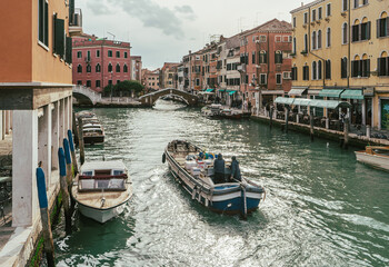 Fototapeta na wymiar Channel in Venice - boats and bridges