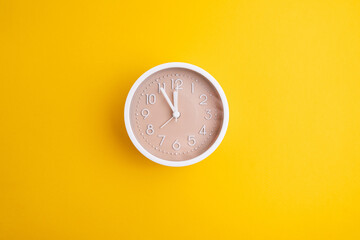 White alarm clock on a colored background. Fashionable minimalist style. Time, business and...