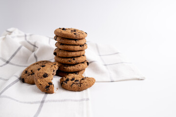 Stack of delicious cookies with chocolate and milk or yogurt on the table. Food and sweet concept. Place for text. Sweet snack