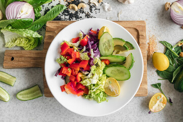 Close-up, fresh vegetable salad on the kitchen table, top view.