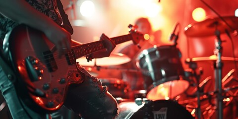 A rock band is playing music at a concert - obrazy, fototapety, plakaty
