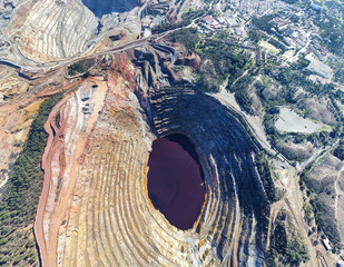 Aerial drone view of Corta Atalaya with mining levels at open mine pit. Deep excavation of pyrite...