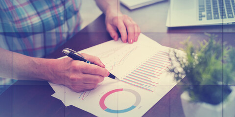 Businesswoman analysing marketing graphs, geometric pattern