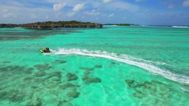 Maldives - Jetski - Kanifinolhu Island - wild action jetski aerial shot in the lagoon