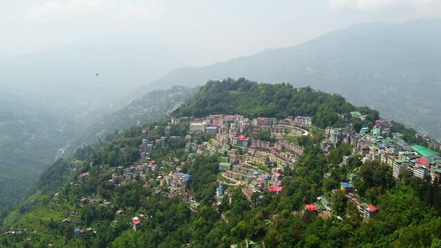Aerial view of the cloudy day in gangtok city capital of sikkim state.A cable car riding towards station at the town center of gangtok, sikkim.