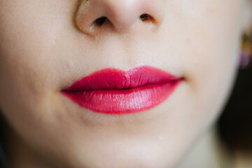 Woman is showing her bright red lips