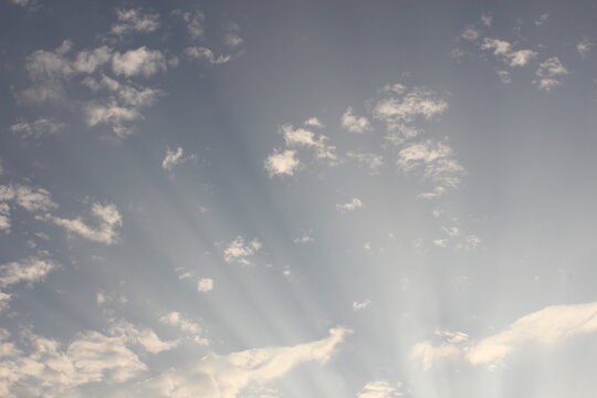The evening sky has light shining through the clouds.