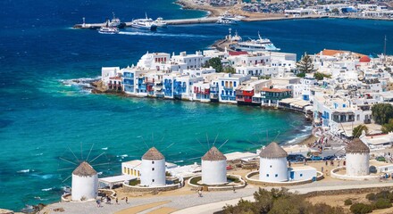 Aerial close-up view through the famous windmills above Mykonos town, Cyclades, Greece, to the Little Venice district