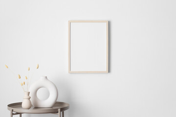 Wooden frame mockup on the wall with a dry flower decoration.