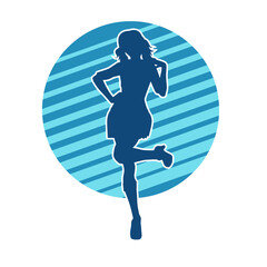Silhouette of a female dancer wearing mini skirt in action pose. Silhouette of a slim woman dancing happily.