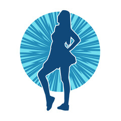Silhouette of a female dancer wearing mini skirt in action pose. Silhouette of a slim woman dancing happily.