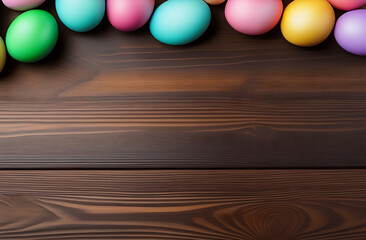 Obraz premium Top view of a composition of multi colored Easter eggs that lie on the table surface, free space for text. Background for a banner for Easter.