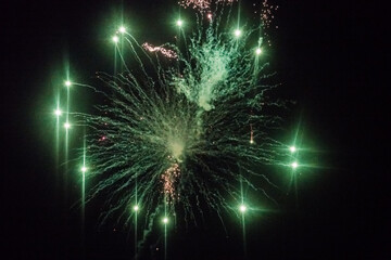 bright green fireworks with lot of smoke in the night on new years eve