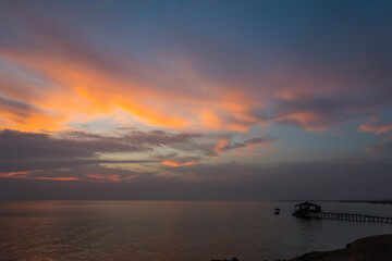 colorful sky during sunrise at the red sea with a jetty on vacation