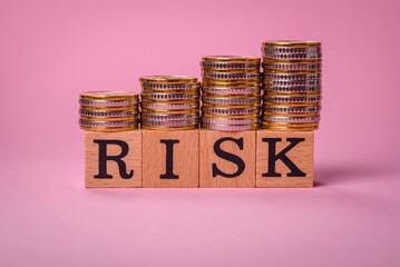 The inscription Risk made of wooden cubes on a plain background