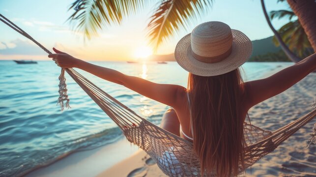 Summer vacations concept, Happy woman with white bikini, hat and shorts Jeans relaxing in hammock on tropical beach at sunset