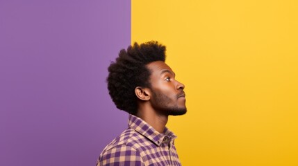Fototapeta na wymiar Photo of upbeat African-American man in yellow plaid shirt gazing into void against violet backdrop, showcasing his side profile