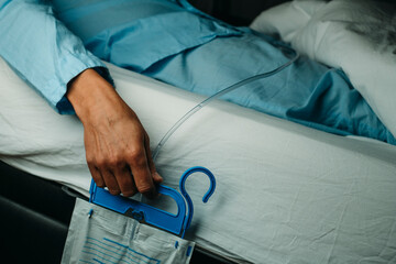man wearing a urine drainage bag in bed
