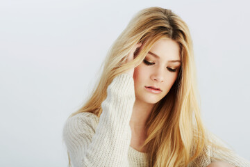 Naklejka premium Face, beauty and makeup with natural woman in studio on white background for style contemplation. Aesthetic, skincare or wellness with confident young blonde model in wool jersey for cosmetics