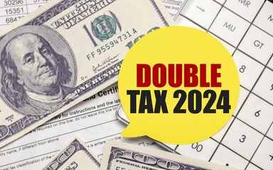 DOUBLE TAX 2024 on yellow sticker with pen and calculator