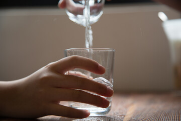 Water glass, water, holding a water glass