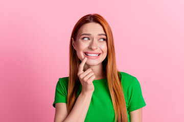 Photo of confused woman with ginger hair dressed green t-shirt look at stomatology ad empty space isolated on pink color background