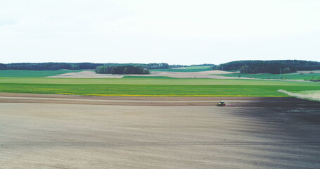 Agricultural background of farmer using tractor