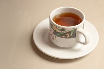 A cup of herbal tea on its saucer. After some edits. 