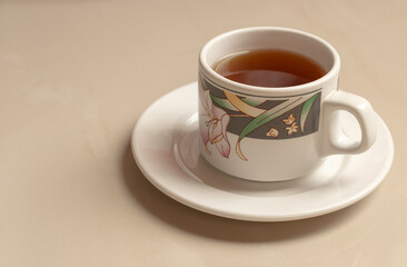 A cup of herbal tea on its saucer. After some edits. 