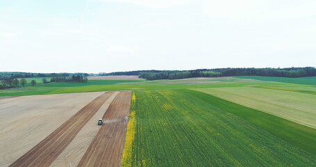 Tractor with plough plowing a field. Agriculture background.