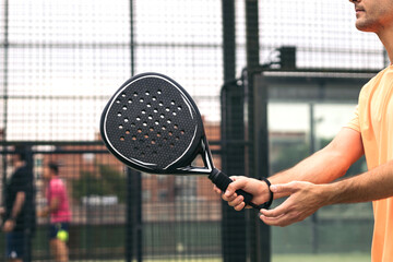 man hand with paddle tennis racket playing