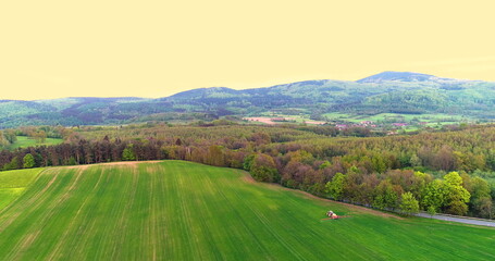 Fototapeta na wymiar Farming. Aerial view of Agricultural tractor spraying field.