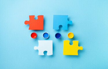 World Autism Awareness Day Card, colorful Puzzles on Blue Background.