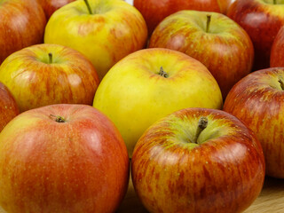 Fresh red-yellow apples are on a board, healthy and organic food, background